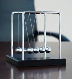 Very little energy is needed to help your body heal itself Newton's Cradle on desk
